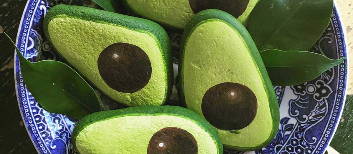 Painted avocado rocks in a bowl